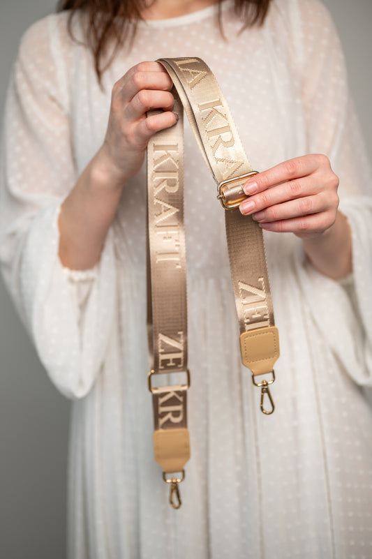 Plecu siksna ar logotipu Bēša